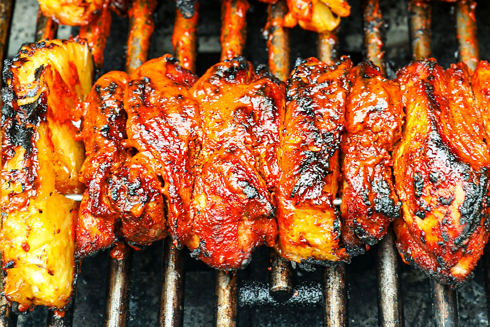 showing how to make al pastor recipe with chicken by grilling on a barbecue grill
