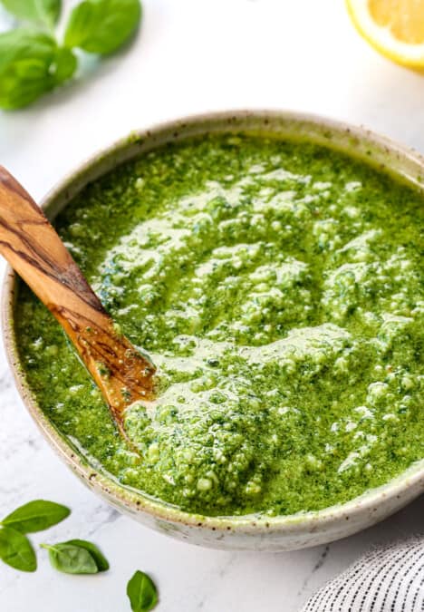 up close of pesto recipe with basil served in a green bowl