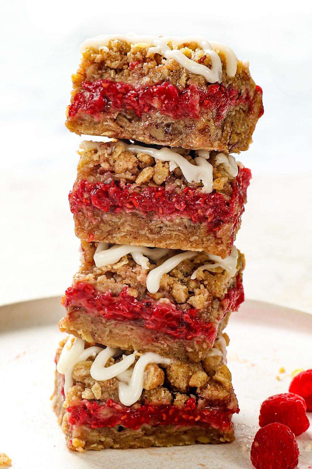 a stack of raspberry bars with oatmeal crumble