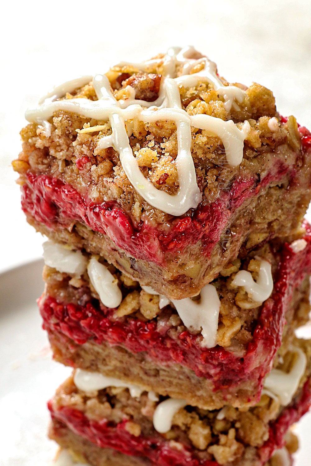 up closer of raspberry crumble bars with oatmeal showing the crispy topping