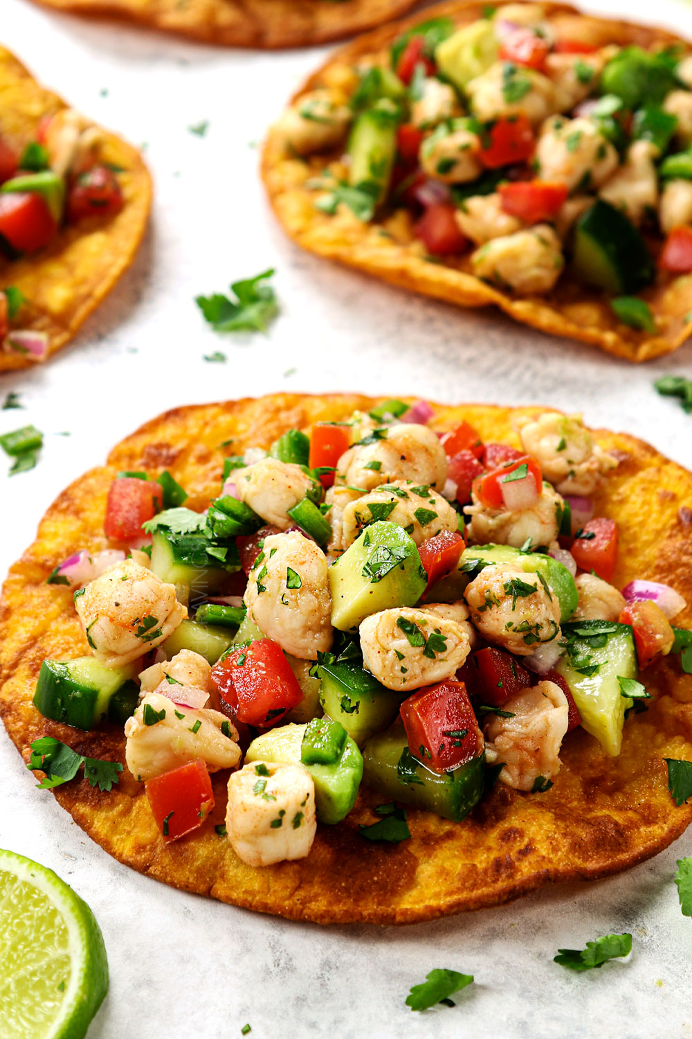 up close of serving shrimp ceviche (ceviche de camaron) by topping a tostada with ceviche
