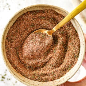 showing how to make Jamaican jerk seasoning by whisking the spices together in a bowl