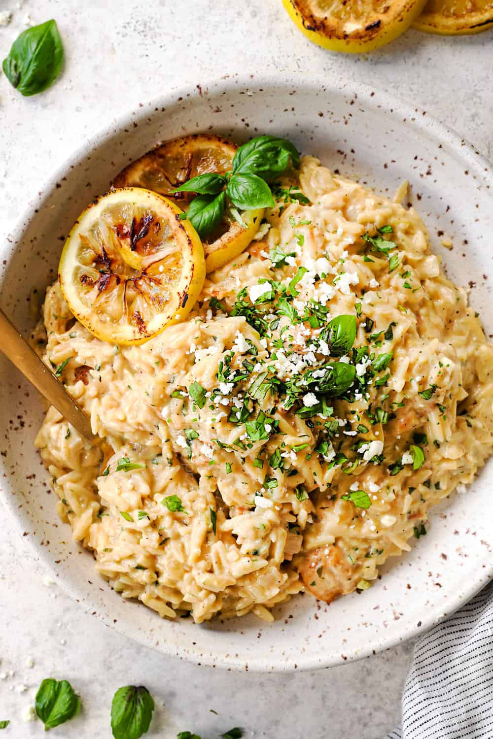 top view of lemon orzo with chicken garnished by basil