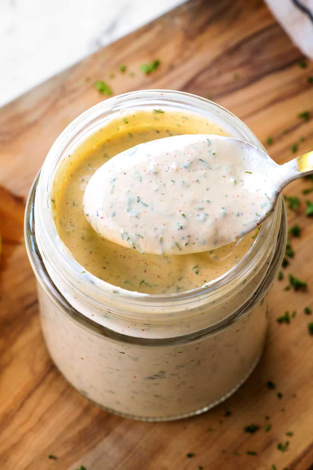 spooning up homemade ranch dressing showing how creamy it is