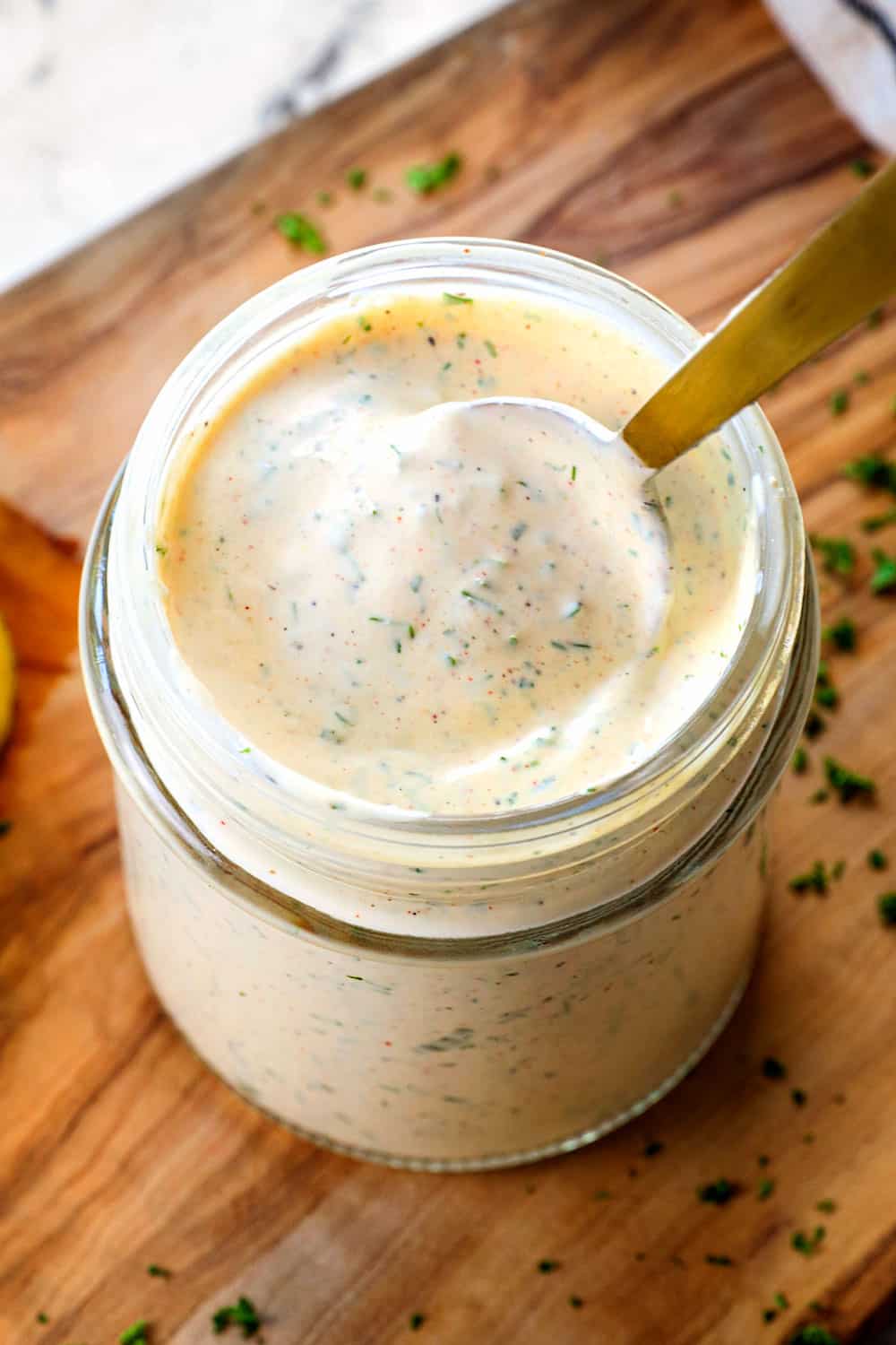 spooning up homemade ranch dressing showing how creamy it is