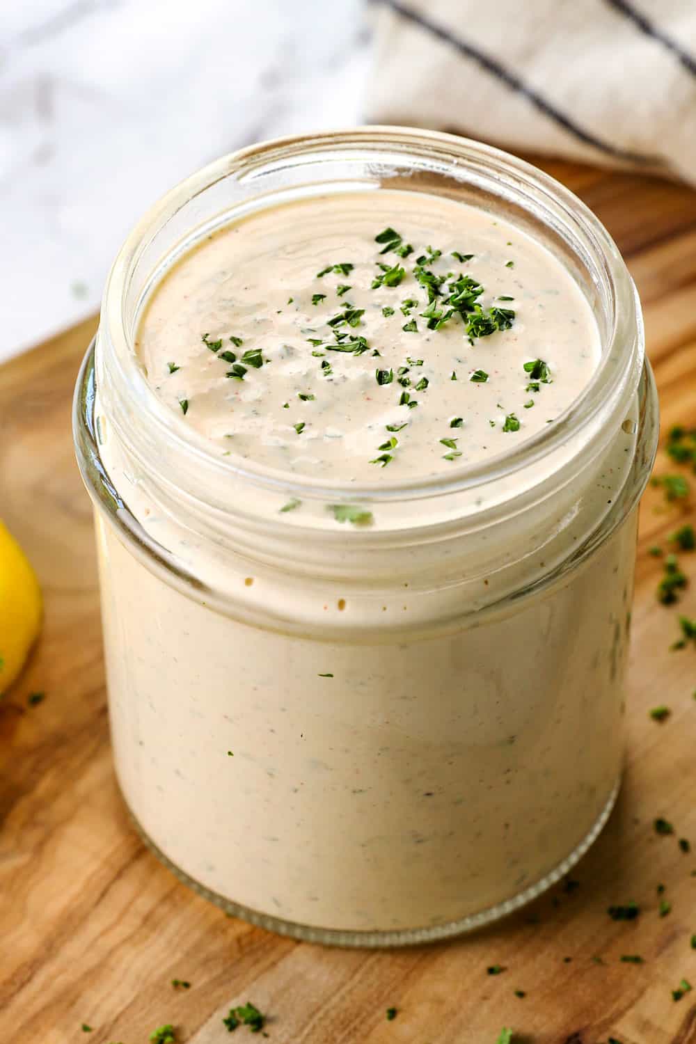 a bottle of homemade ranch dressing recipe with fresh herbs