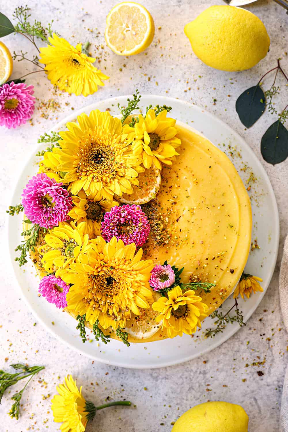 top view of lemon cake with lemon curd decorated with flowers