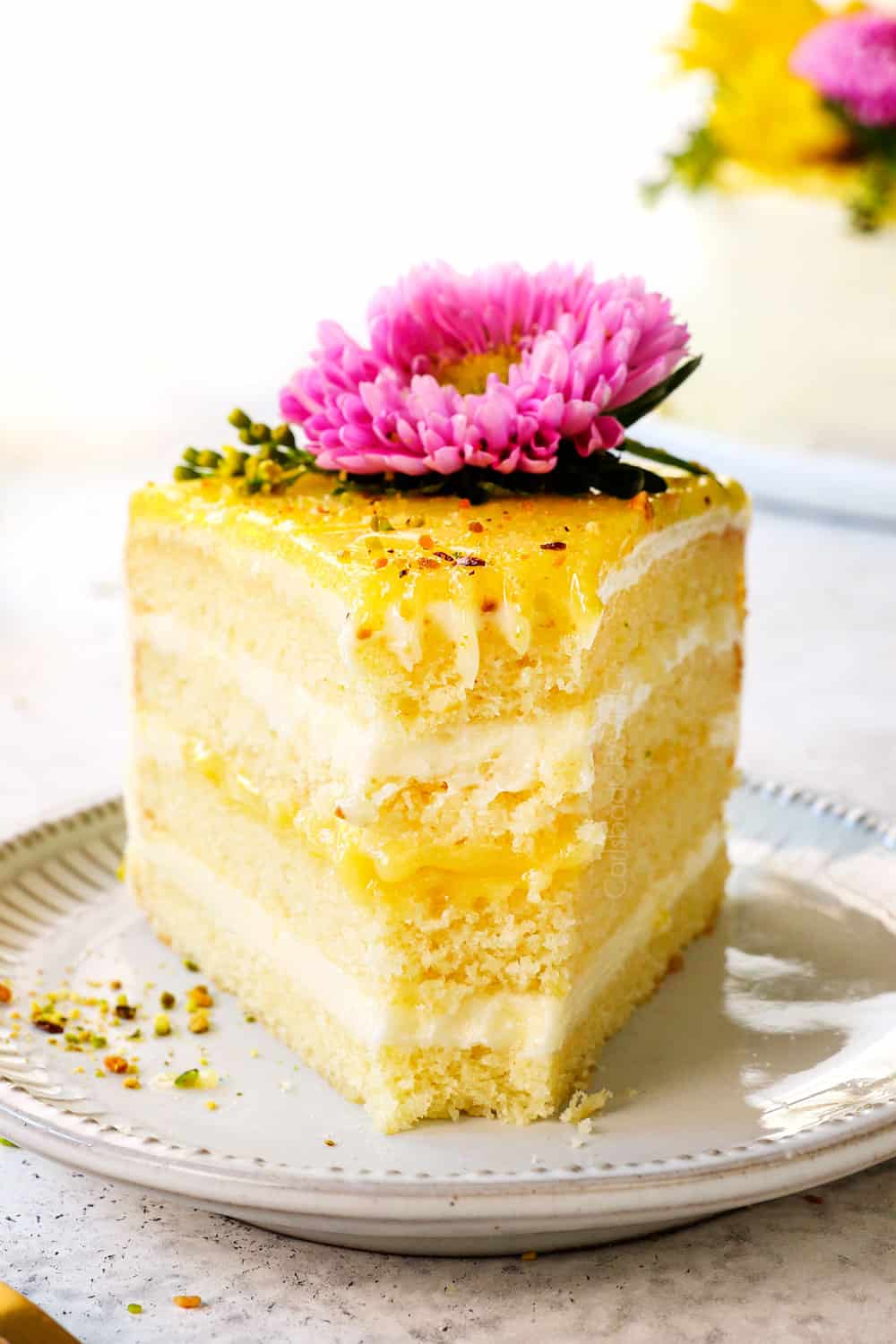 up close front view of up close of moist lemon cake with a bite taken out showing how soft and tender it is