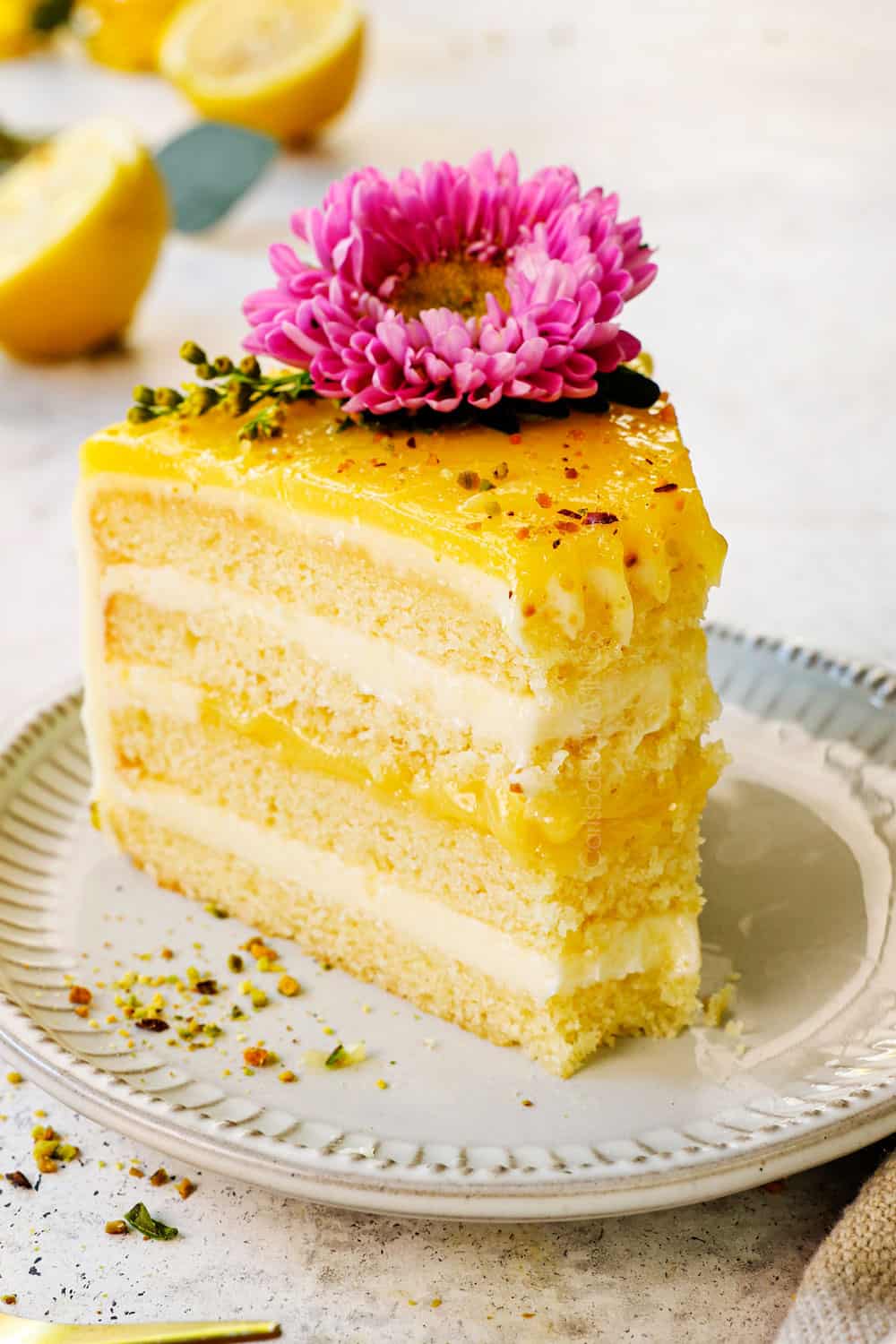 up close of moist lemon cake with a bite taken out showing how soft and tender it is