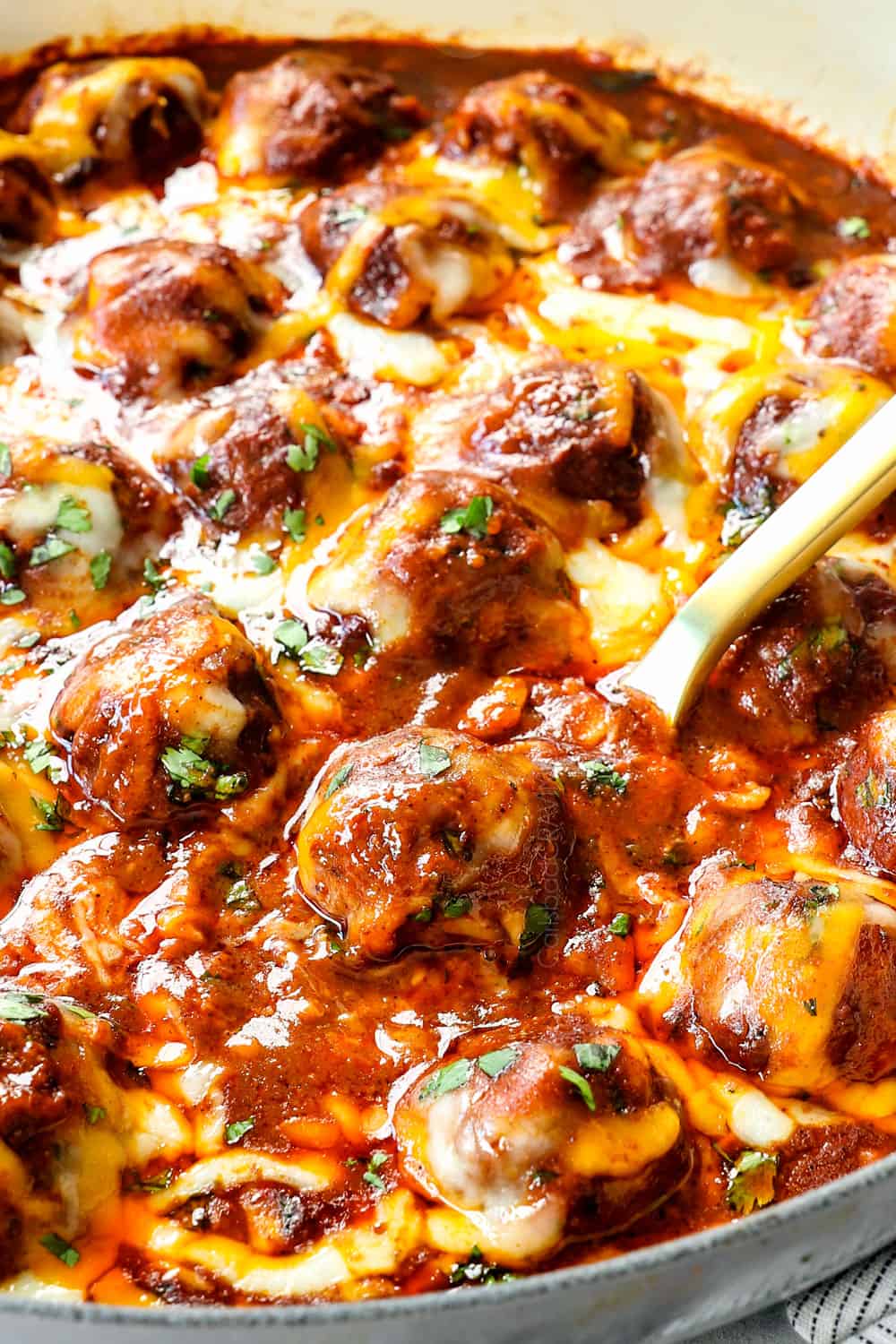 up close of a enchilada meatballs covered in cheese