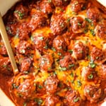 top view of enchilada meatballs in a skillet with cheese