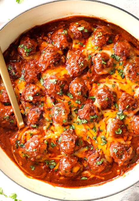 top view of enchilada meatballs in a skillet with cheese