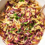 top view of coleslaw recipe by showing coleslaw ingredients of cabbage, carrots and green onions