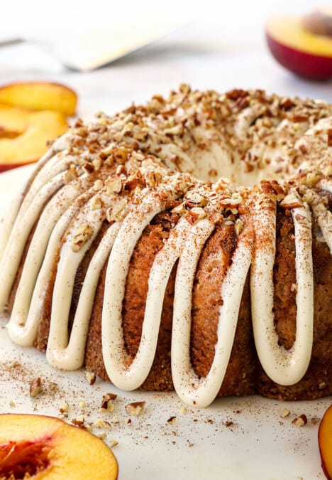 up close of peach cake recipe with fresh peaches garnished with pecans