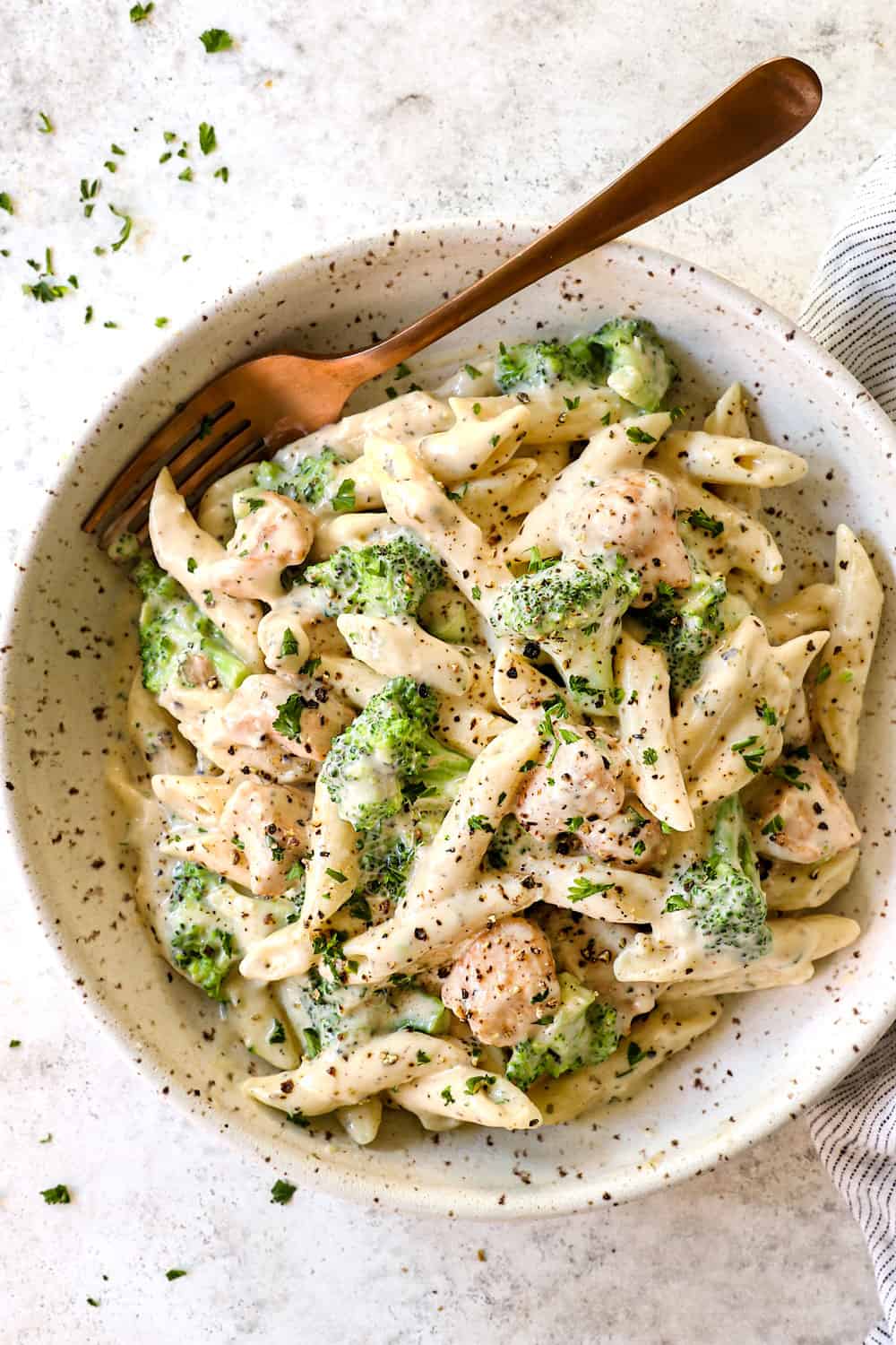 serving broccoli chicken alfredo in a bowl showing how creamy it is