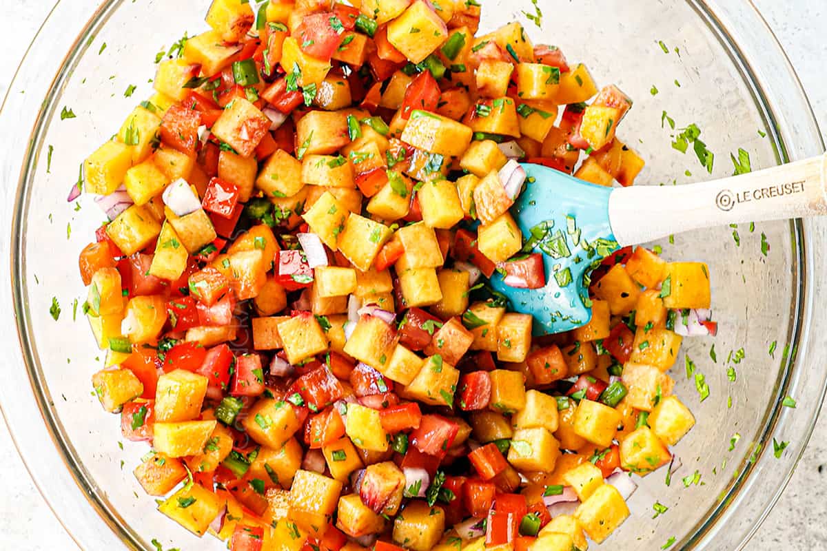 showing how to make Firecracker salmon  by adding peach salsa ingredients to a bowl