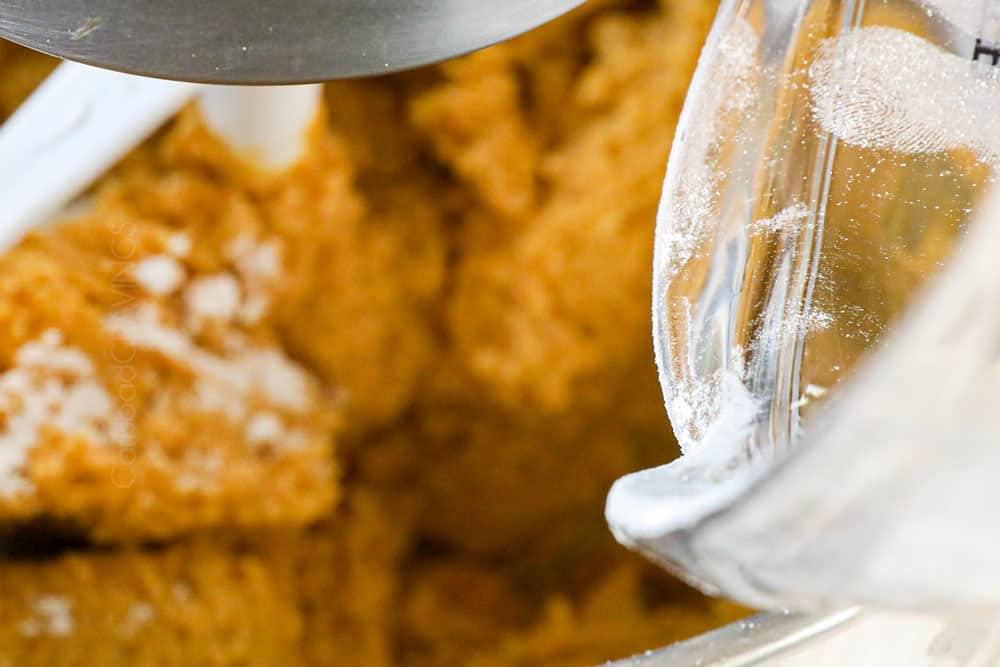 showing how to make pumpkin snickerdoodles by mixing in dry ingredients into wet ingredients