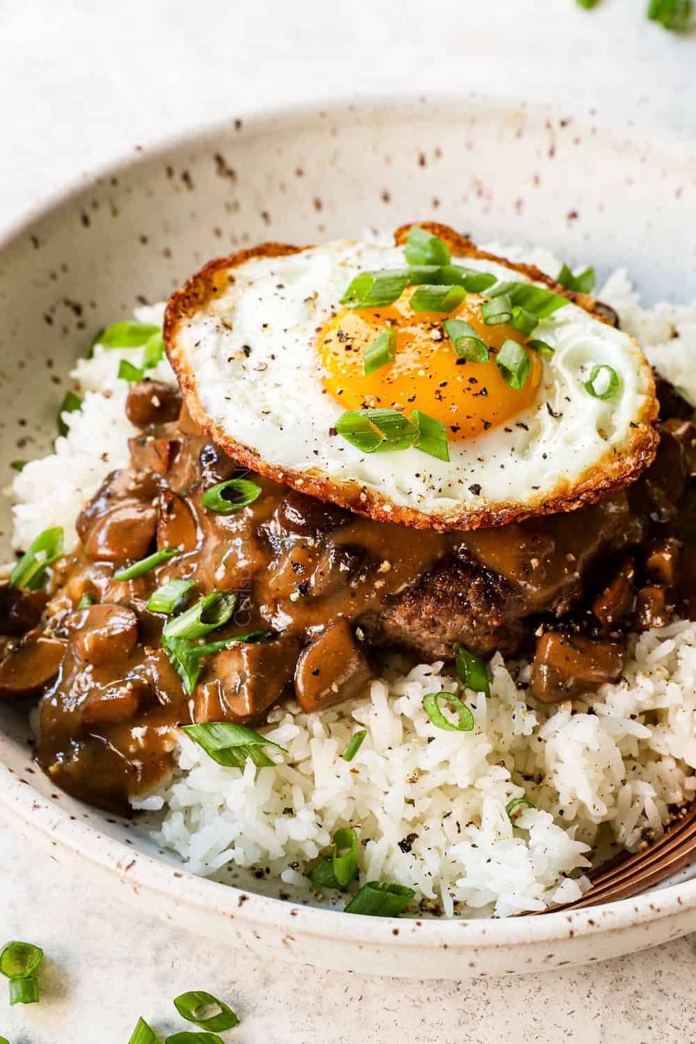loco moco recipe with hamburger patty, mushroom gravy and fried egg served over white steamed rice