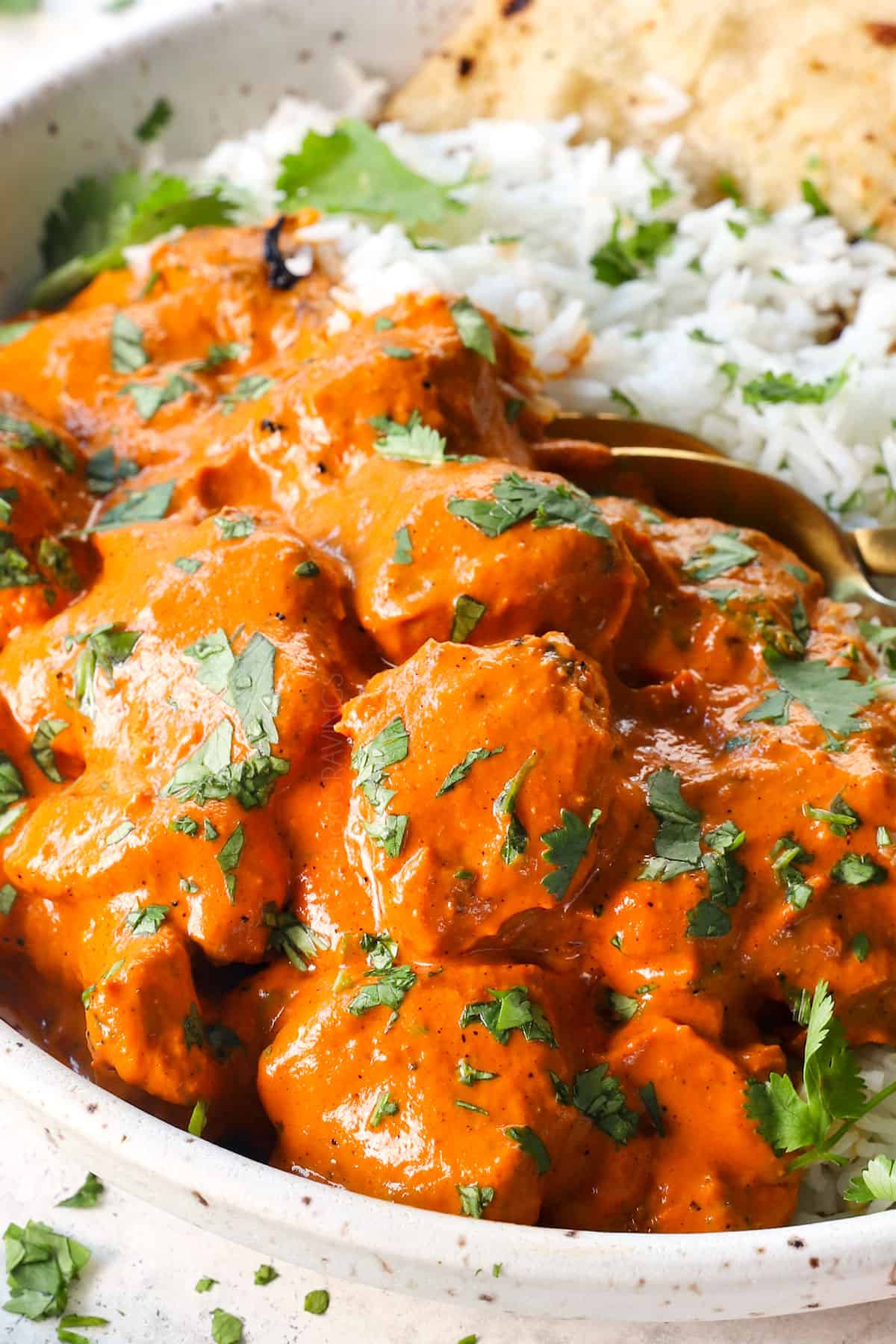 tikka masala with chicken served with rice and cilantro