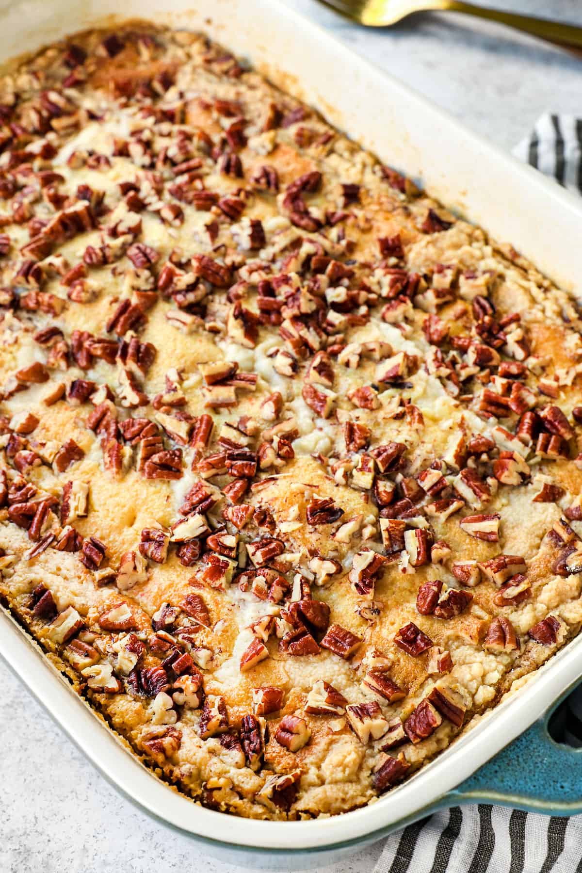 showing how to make pumpkin dump cake recipe by baking until the top cake layer is golden 