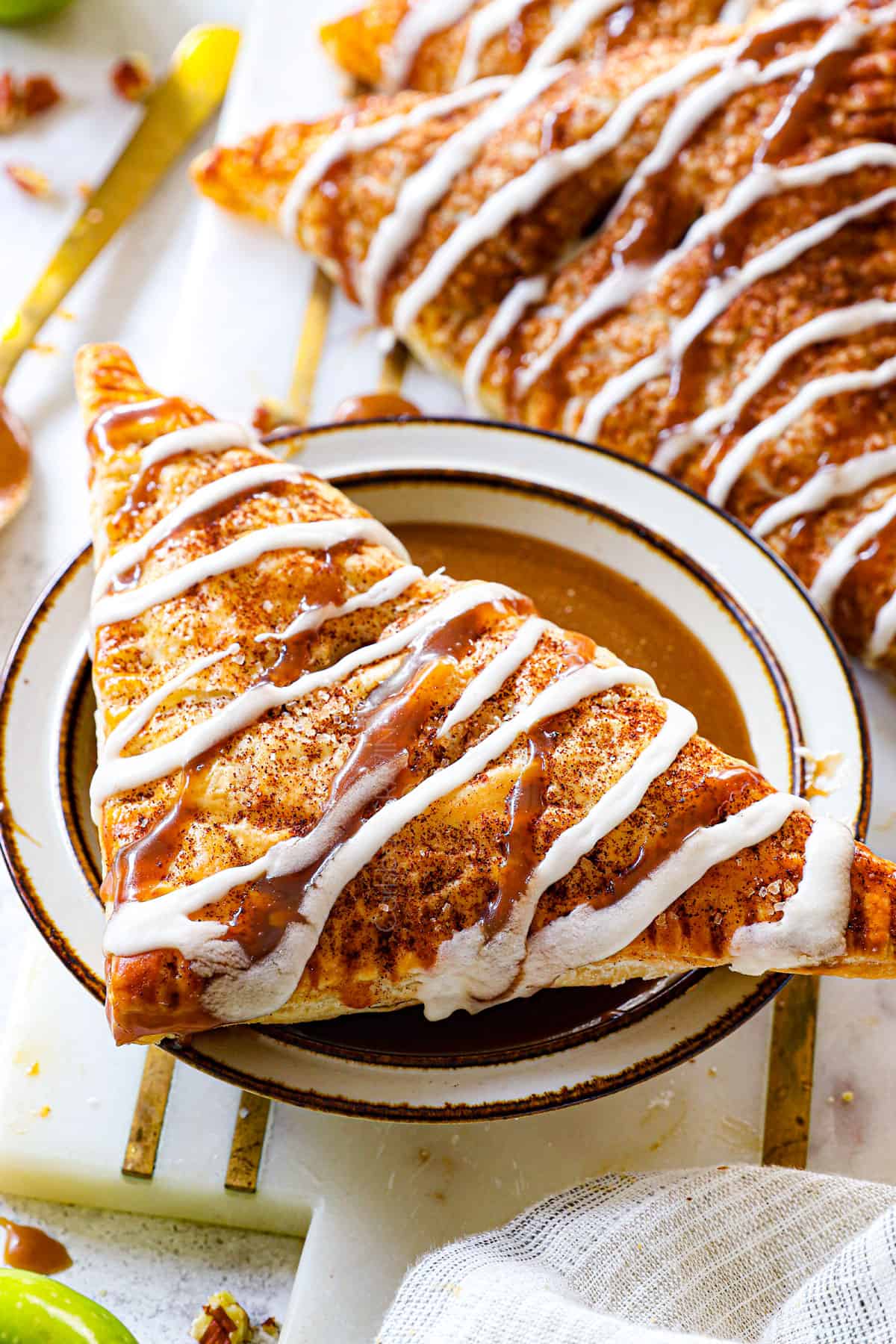apple turnover being served with caramel sauce
