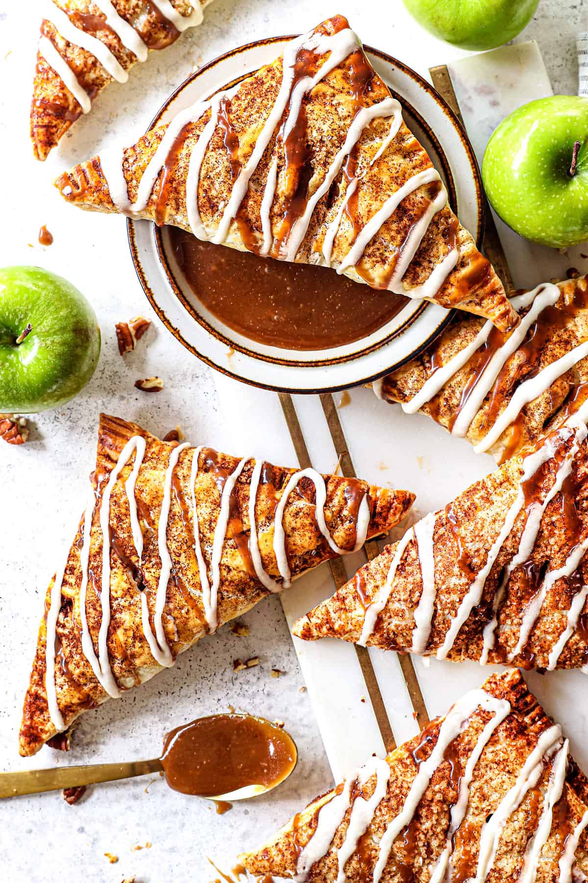 top view of apple turnovers drizzled with vanilla glaze