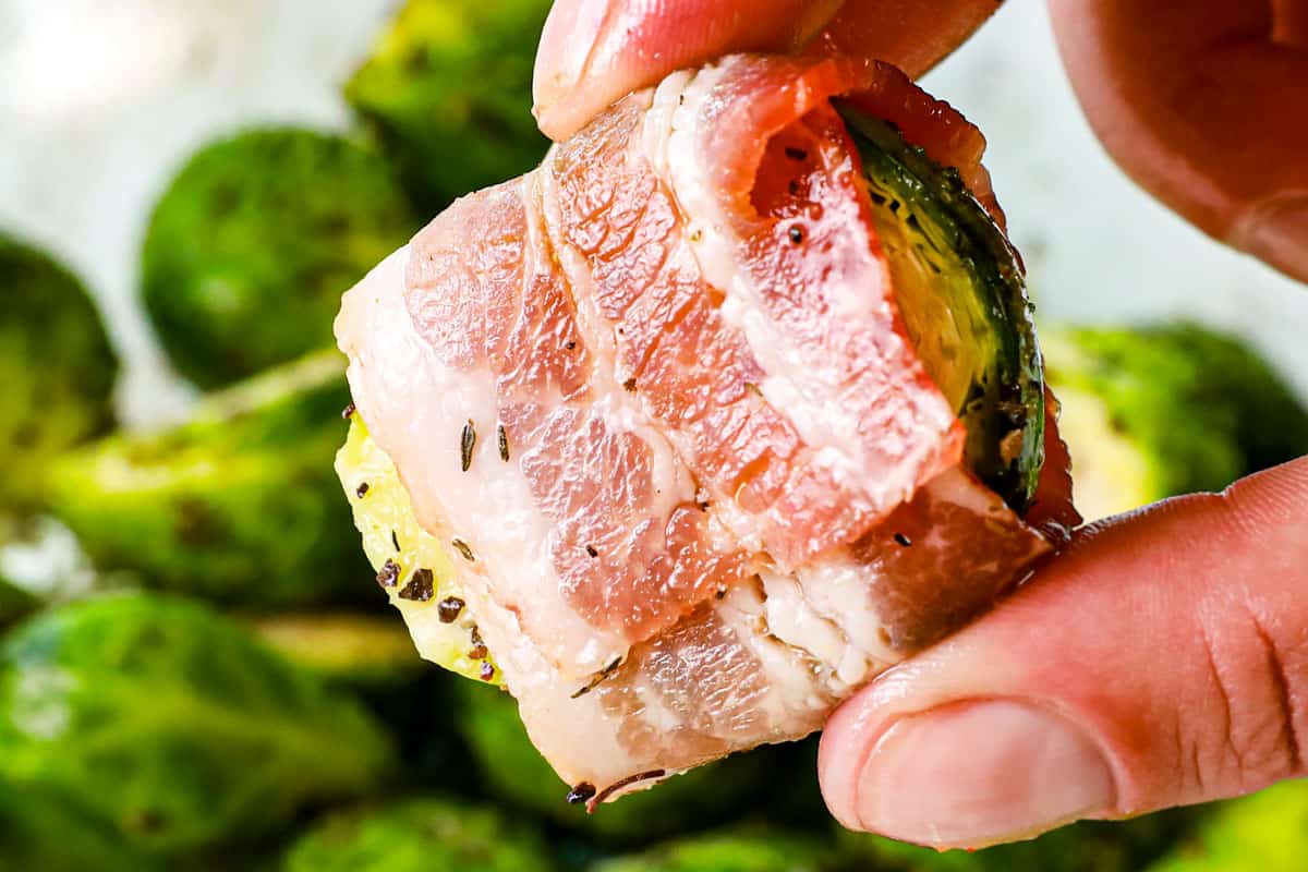 showing how to make Bacon Wrapped Brussels Sprouts by wrapping sprouts in bacon