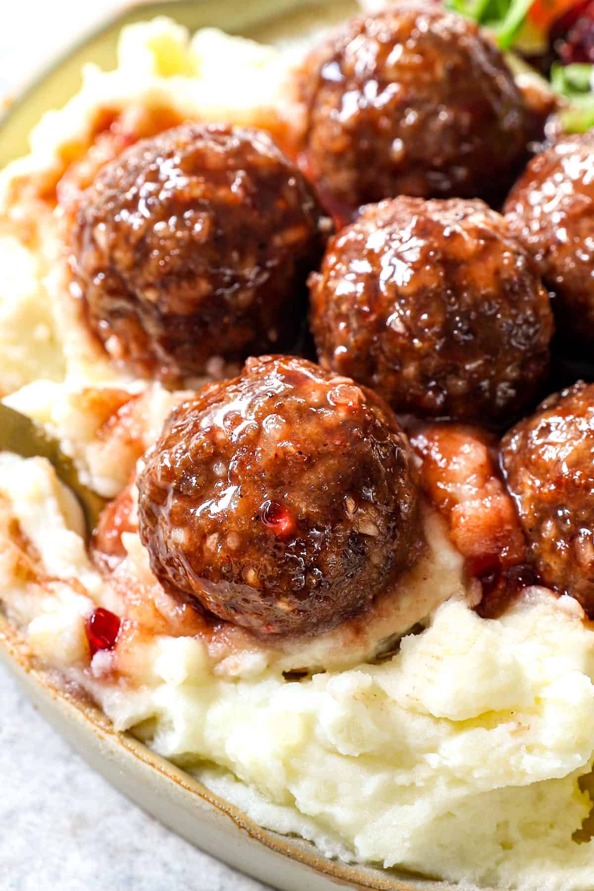 showing how to serve crockpot grape jelly meatballs by spooning over mashed potatoes