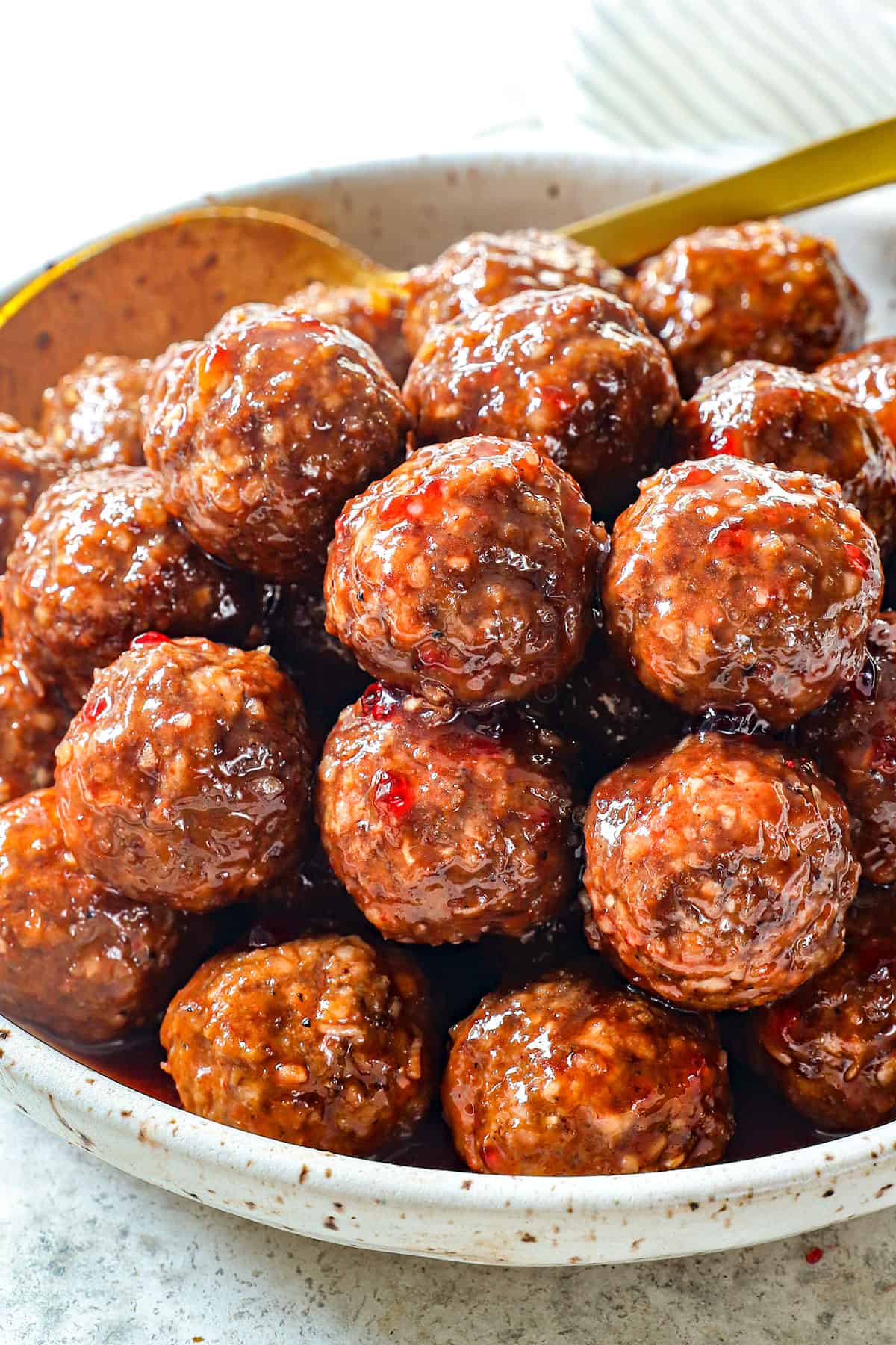 meatballs with grape jelly in a serving bowl showing how juicy they are