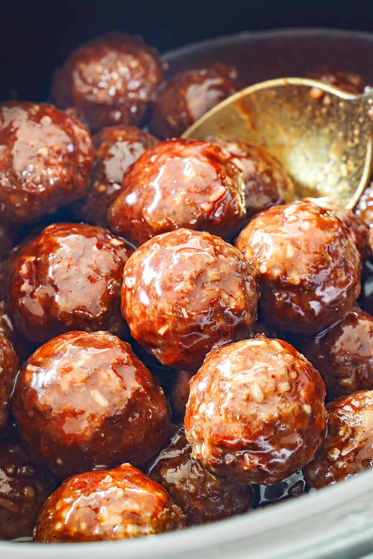 showing how to make meatballs with grape jelly by cooking in the crockpot until cooked through