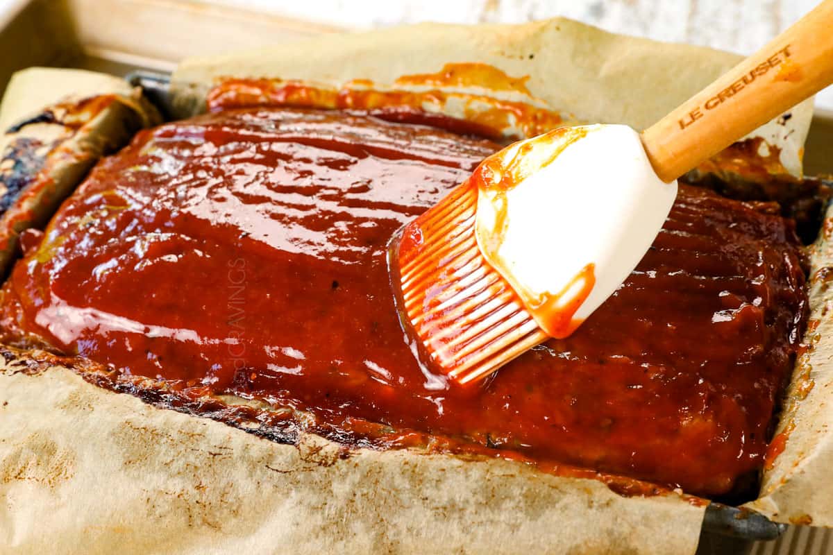 showing how to make meatloaf recipe by brushing with glaze after baking