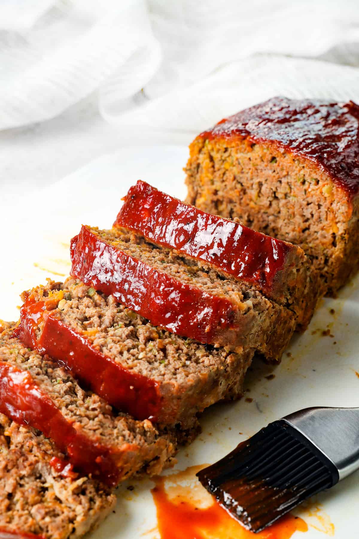best meatloaf recipe sliced on a cutting board showing how juicy it is