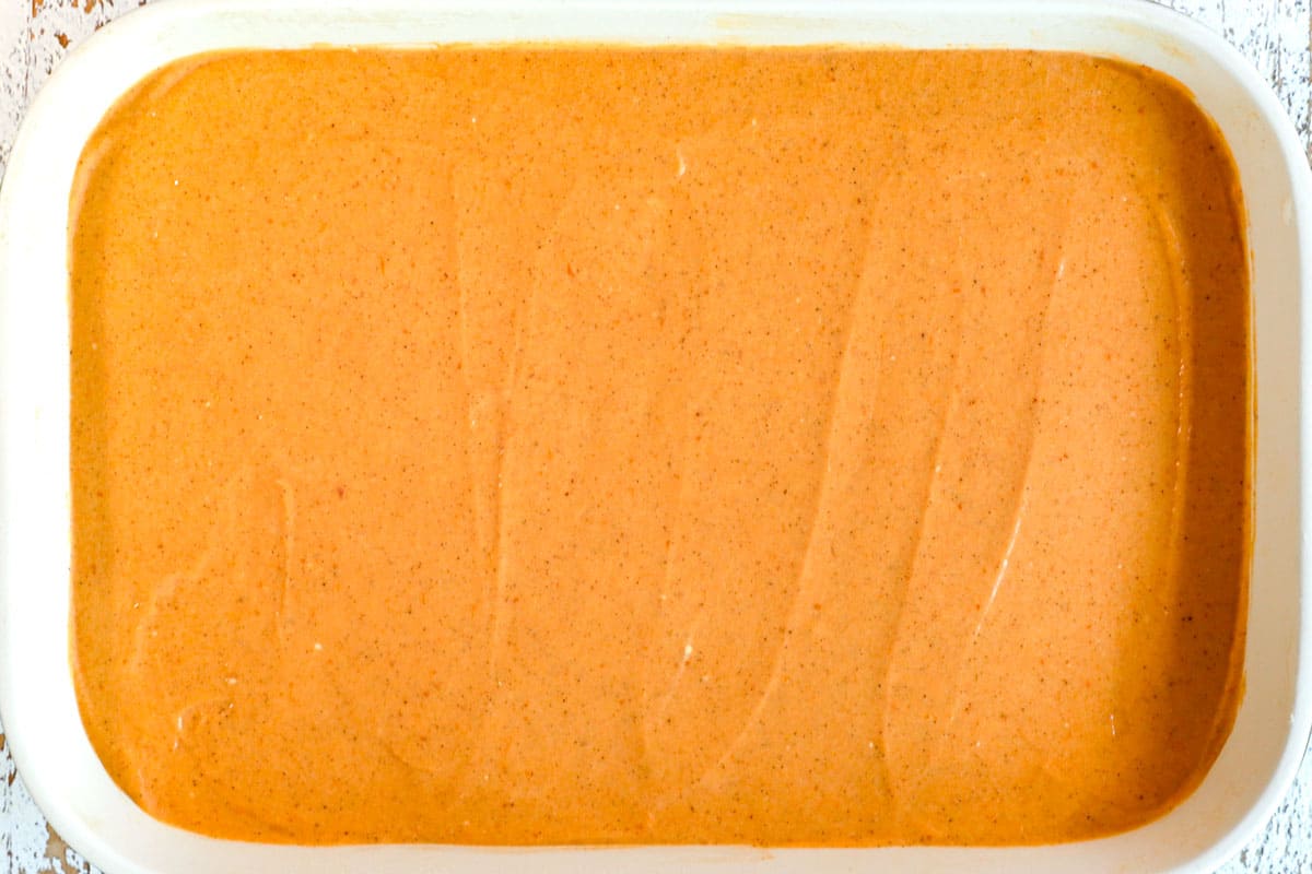 showing how to make pumpkin delight (pumpkin lush) by spreading a layer of pumpkin fluff over the cream cheese