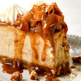 a slice of caramel apple cheesecake with a bite taken out showing how creamy it is