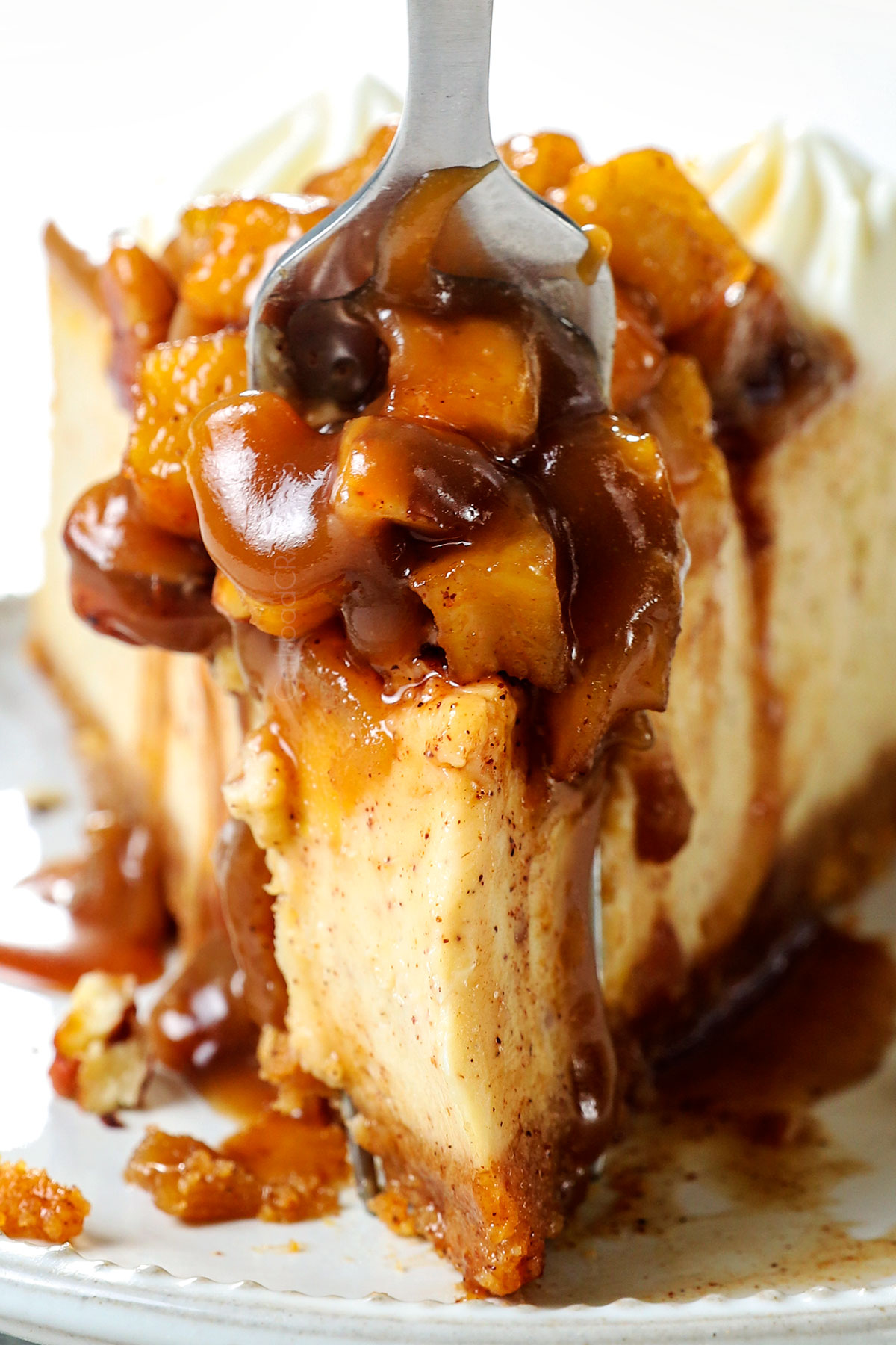caramel apple cheesecake drizzled with caramel topped with whipped cream