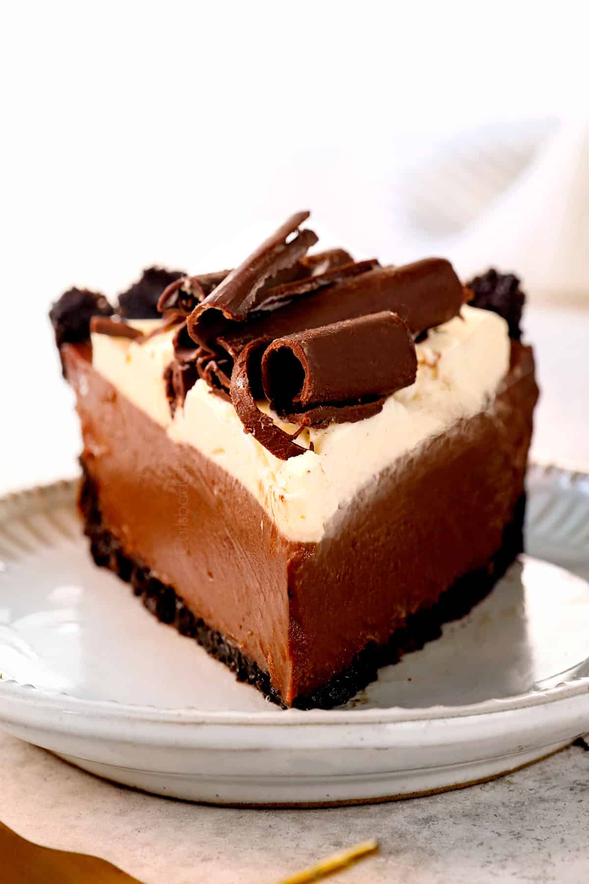 up close of a slice of chocolate cream pie topped with chocolate shavings