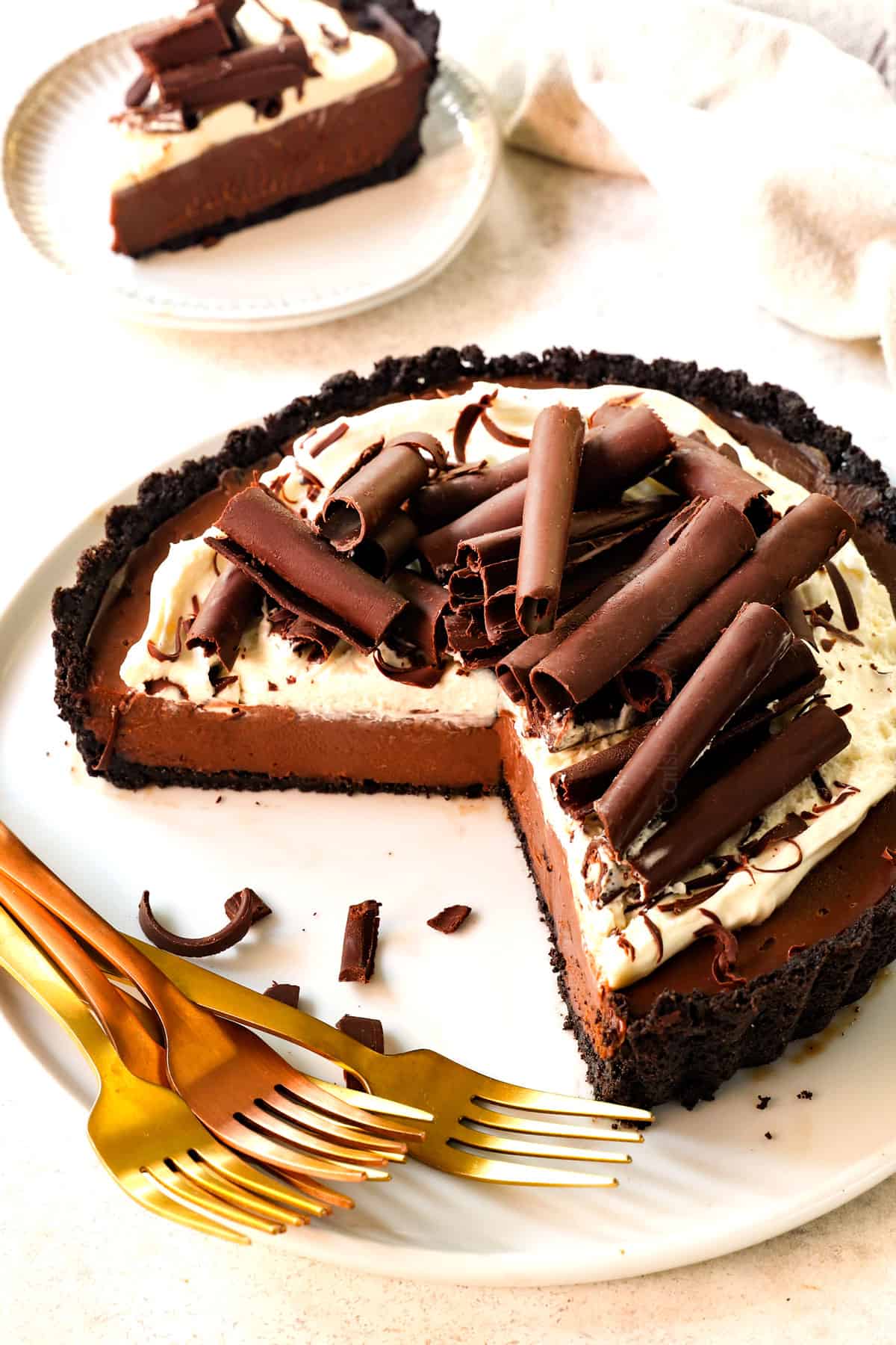 side view of chocolate cream pie with a few slices missing showing the creamy filling