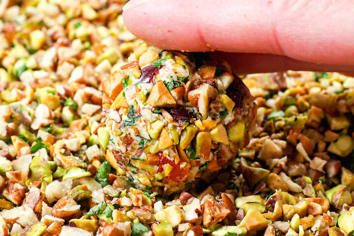 showing how to make mini cheese balls by rolling in pecans and pistachios