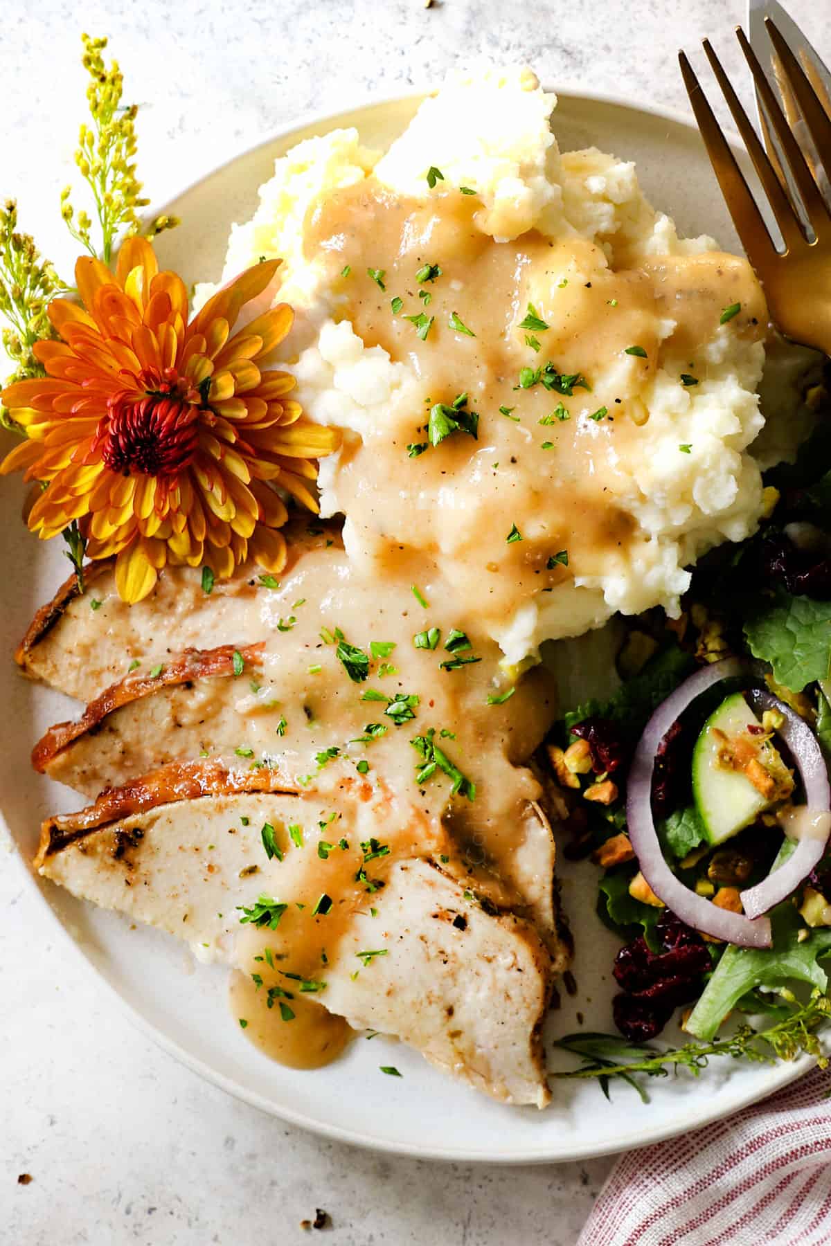 showing how to serve roast turkey breast recipe on a plate with mashed potatoes and gravy