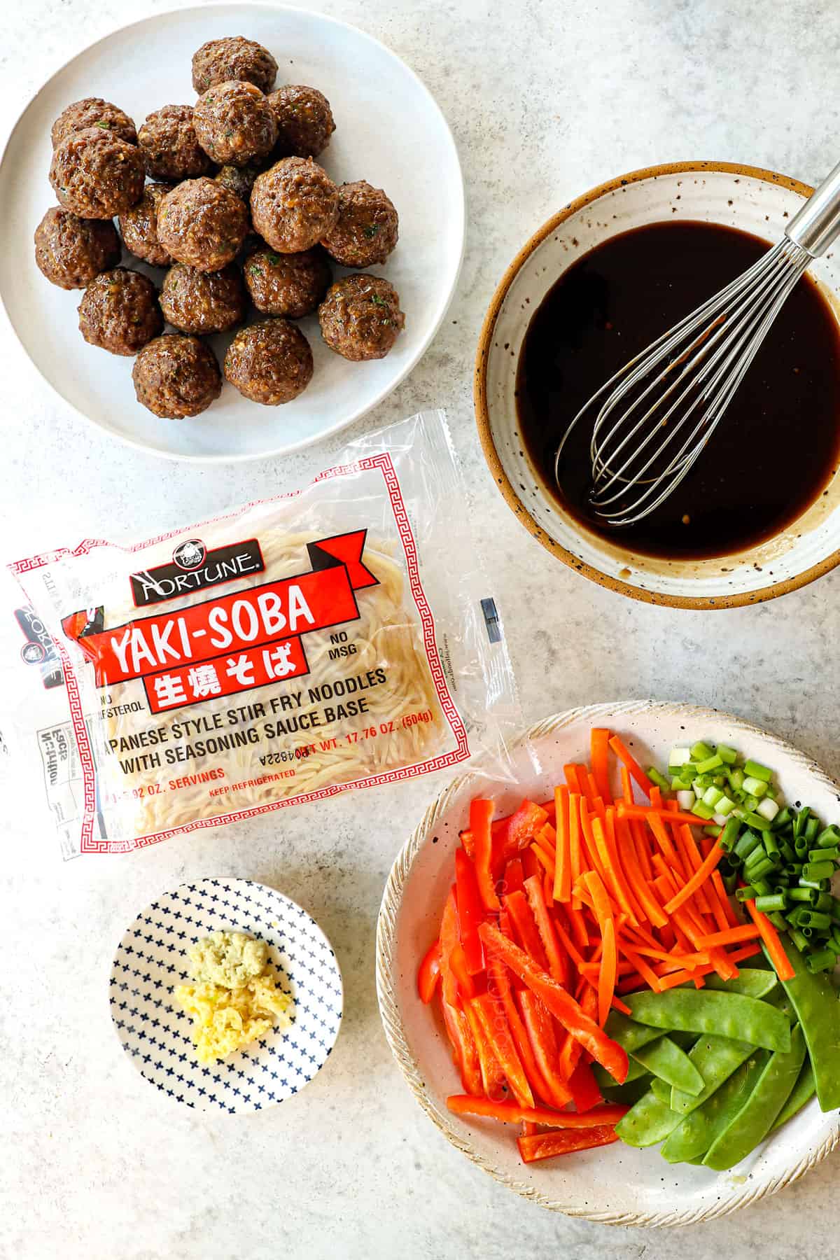 top view of Asian meatball recipe ingredients with Asian meatballs, stir fried vegetables and stir fry sauce
