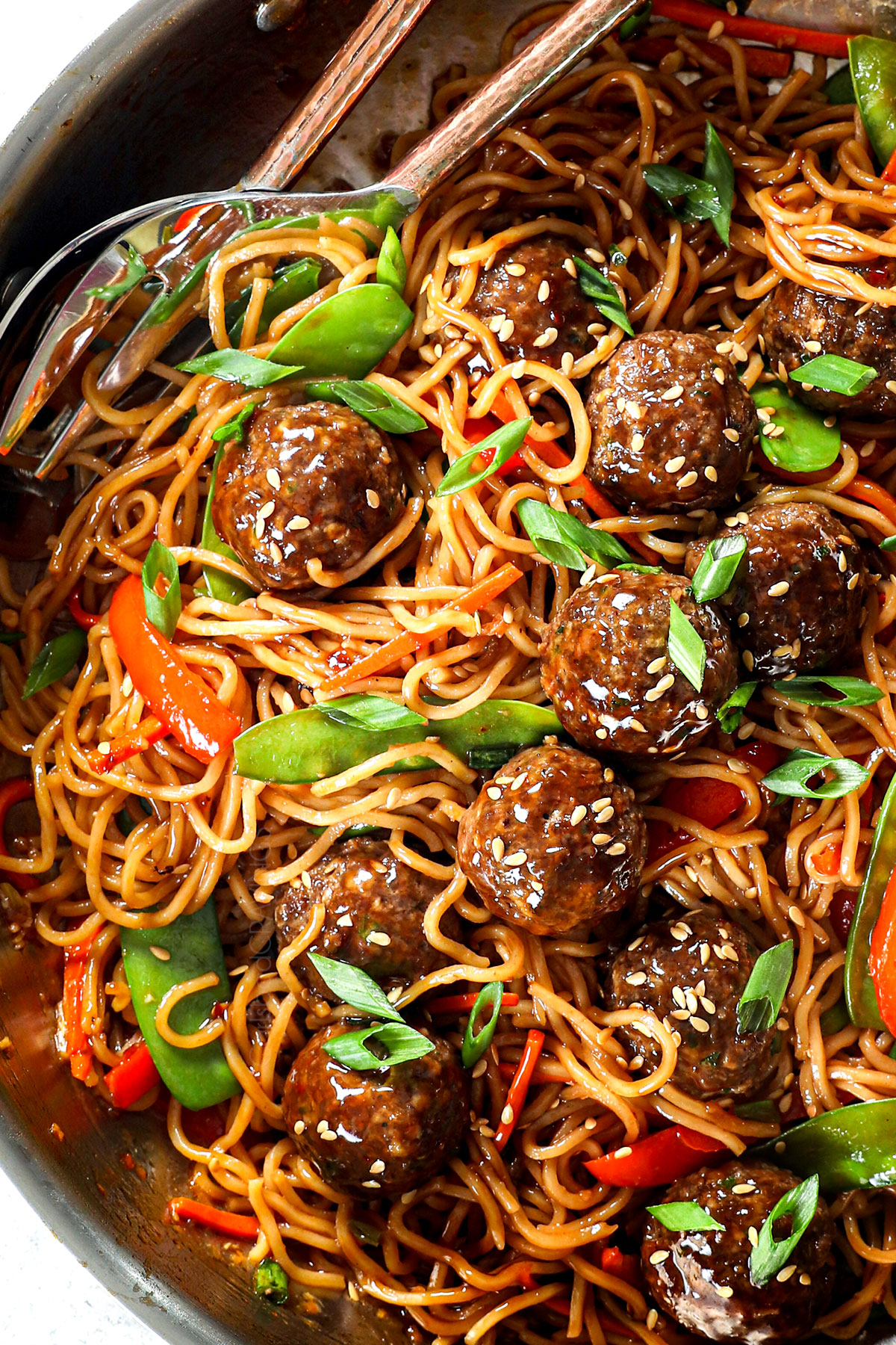 showing how to make Asian meatballs by stir frying the meatballs with sauce and vegetables