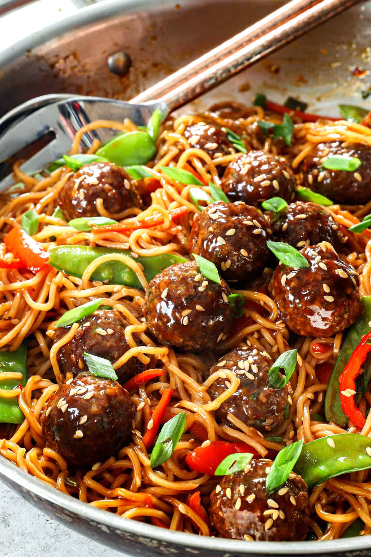 showing how to make Asian meatballs by combining meatballs and sauce