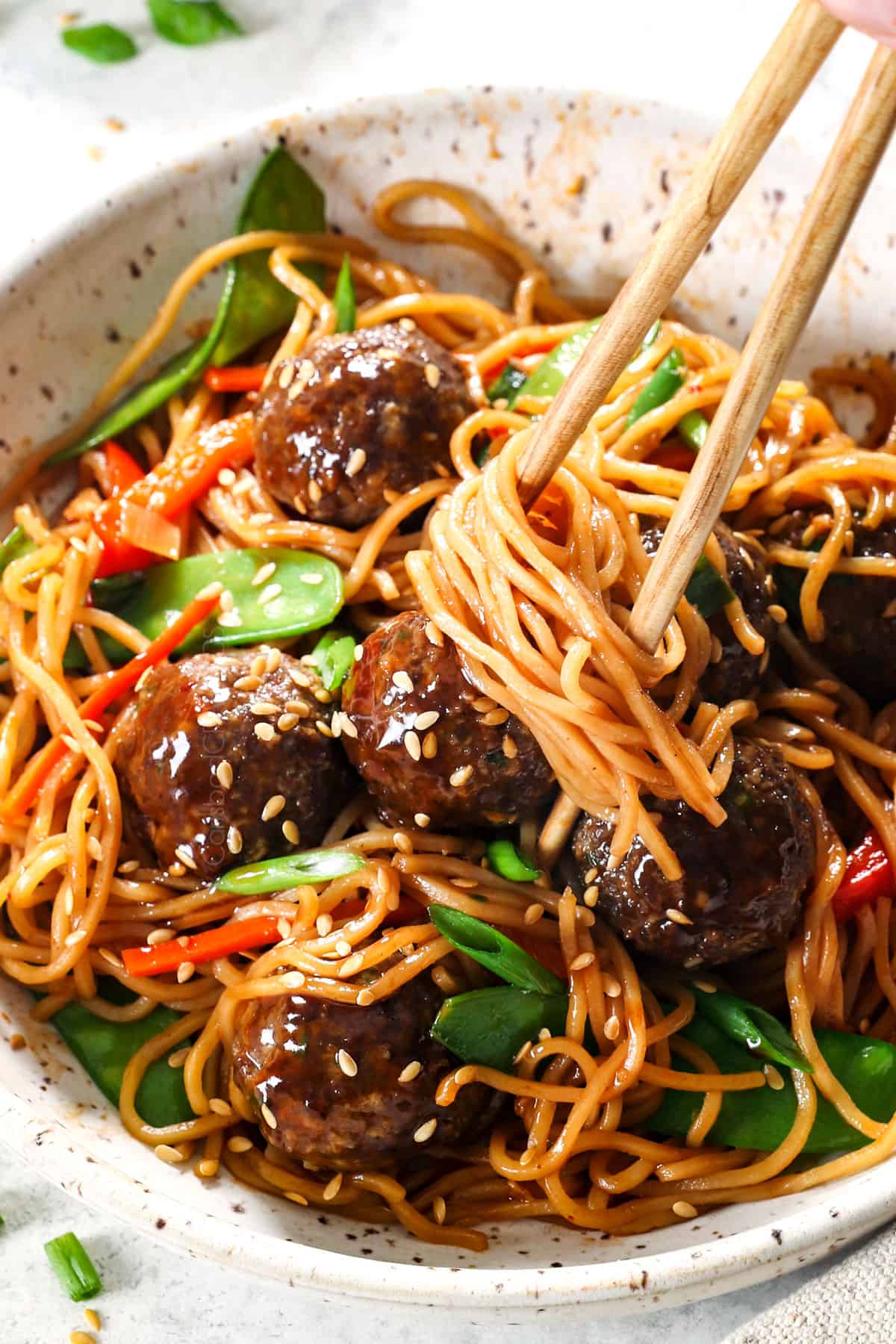 serving Asian meatballs in a bowl with sticky sauce 