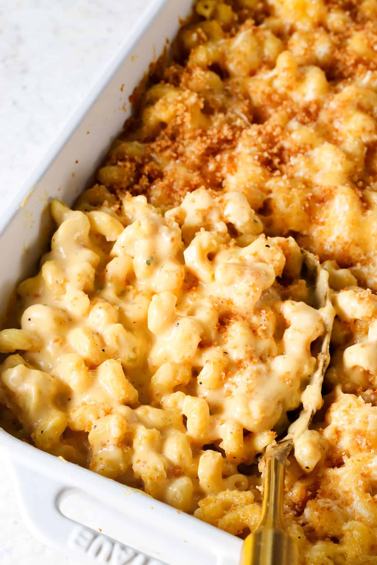showing how to make the best baked macaroni and cheese recipe by baking until the panko is bubbly