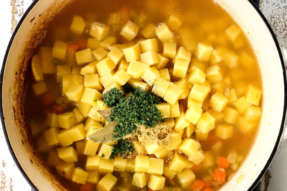 showing how to make Ham and Potato Soup by adding potatoes, herbs and chicken broth to the soup