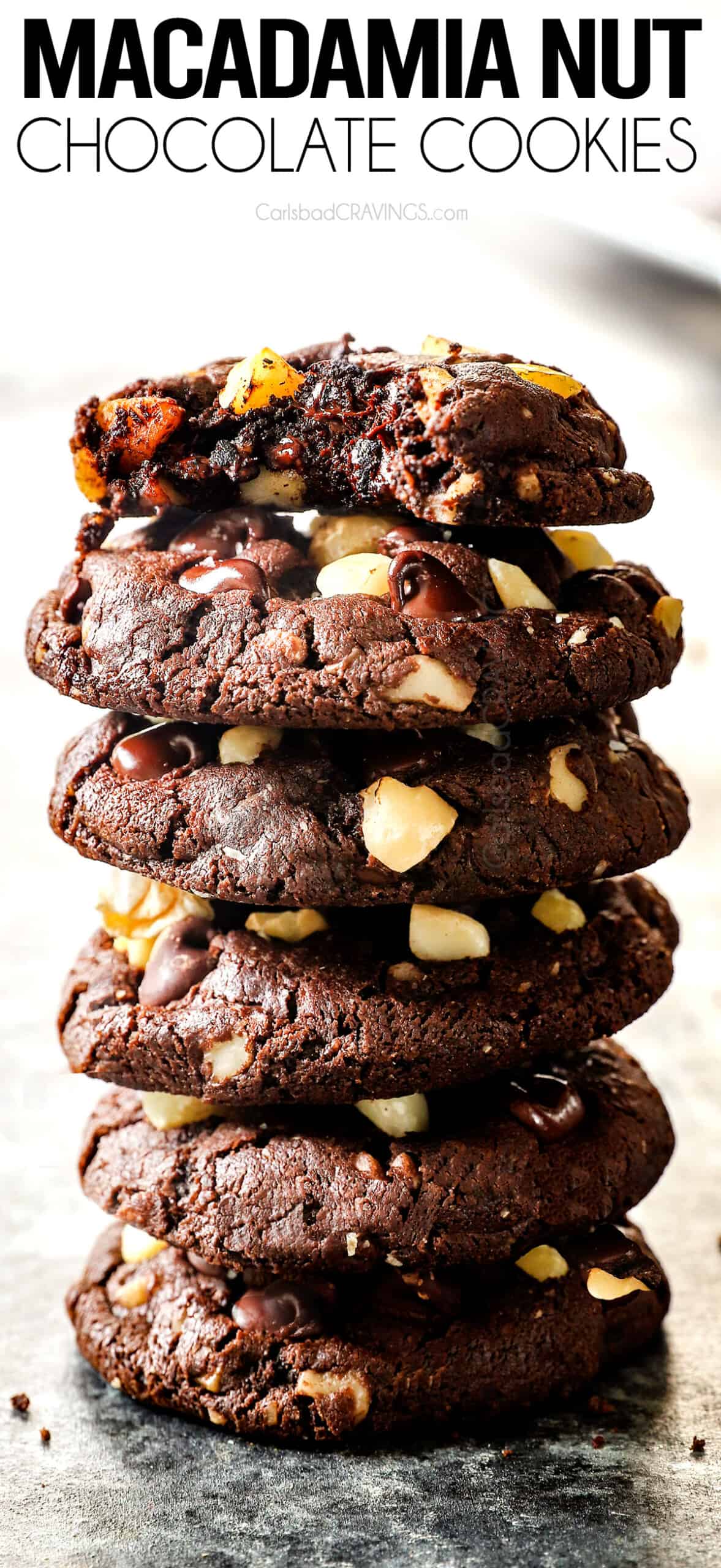 a stack of macadamia nut cookies with a bite taken out of a cookie showing the macadamia nuts and melted chocolate inside