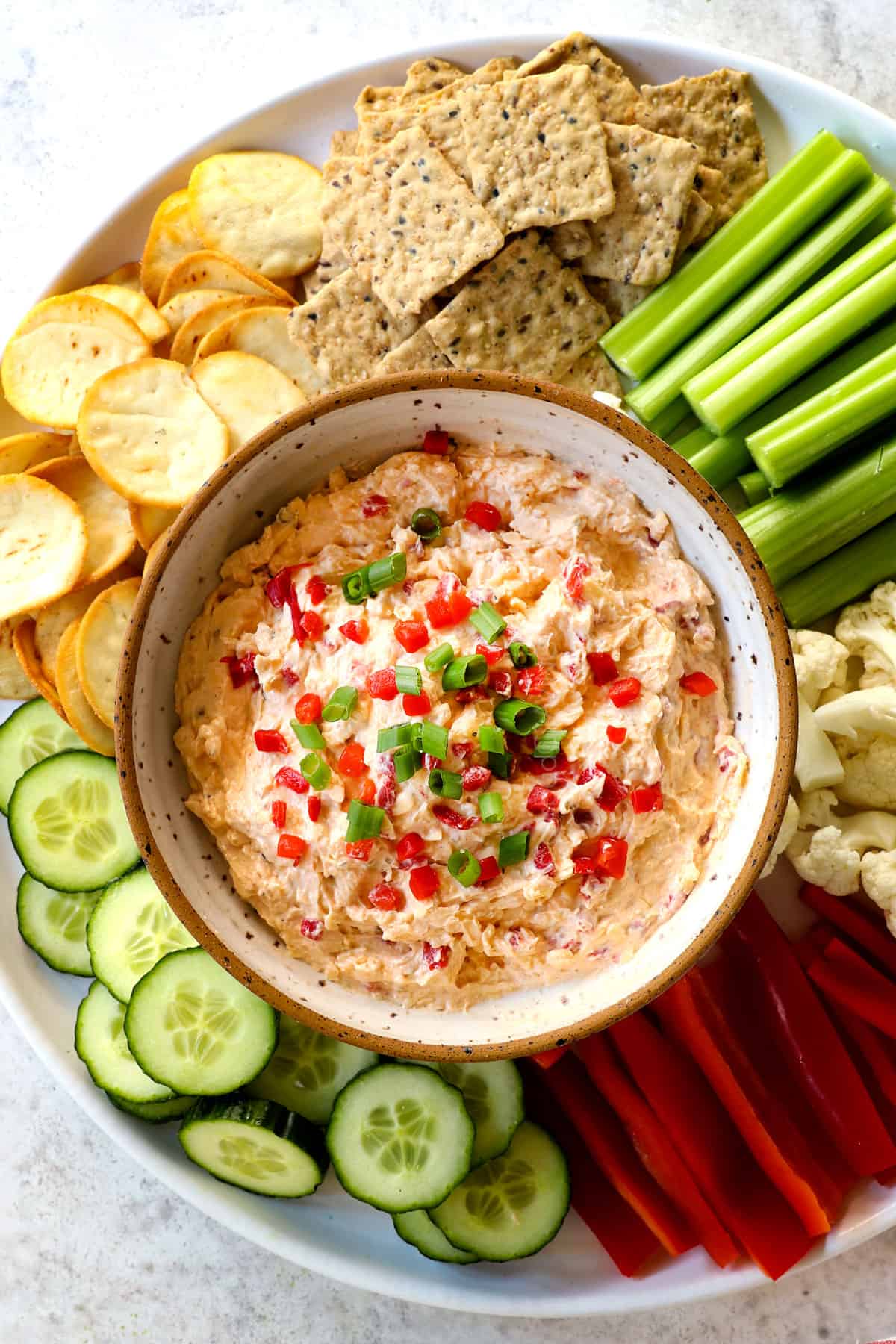 top view of serving pimento cheese on a platter as a dip with vegetables and crackers