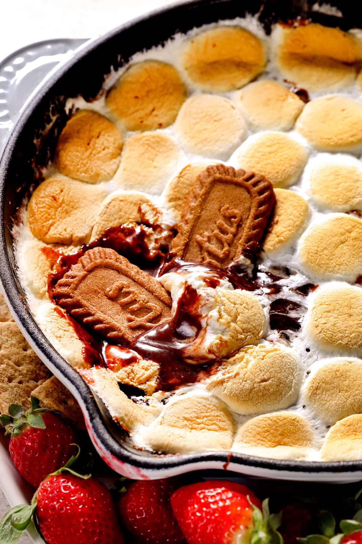 a skillet of s'mores dip made in the oven with melted chocolate