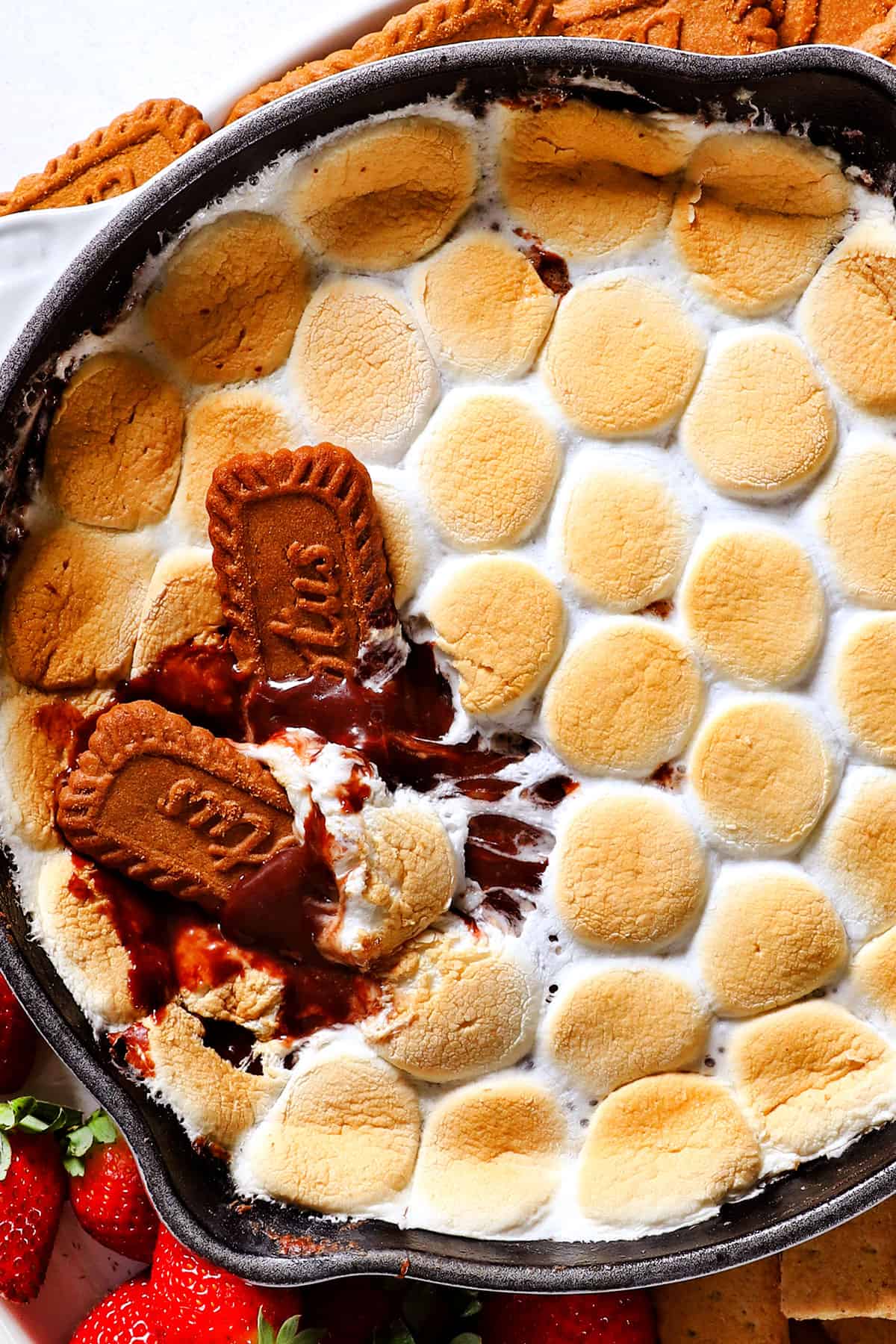 top view of s'mores dip recipe made with chocolate chips and marshmallows in the oven