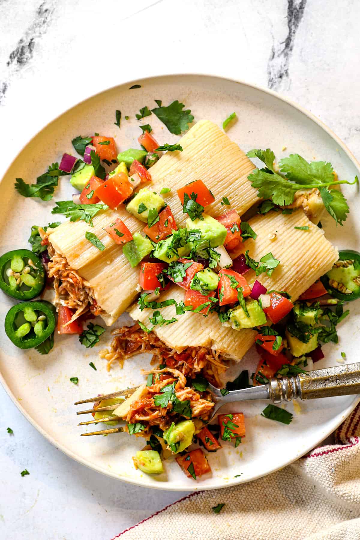 top view of serving Mexican tamale with pico de gallo